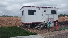 Vecino Construction Work Trailer moved to the Site 